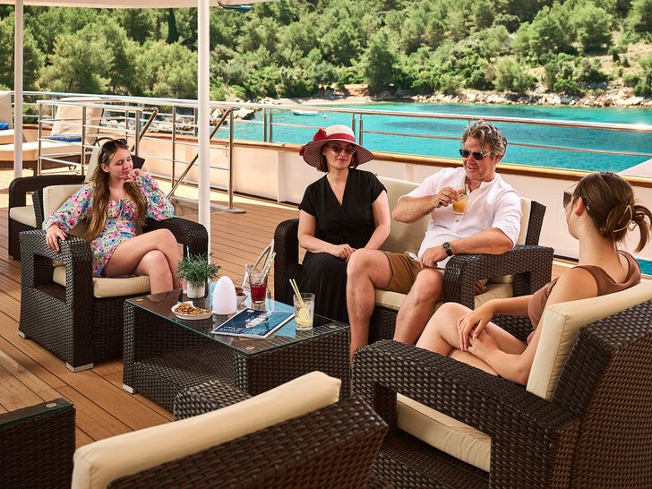 QUEEN ELEGANZA Custom Motor Yacht 49m - guests lounging alfresco QUEEN ELEGANZA Custom Motor Yacht 49m - guests lounging alfresco