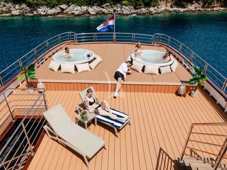 SYMPHONY Custom Yacht 52m - guests basking in the sun SYMPHONY Custom Yacht 52m - guests basking in the sun