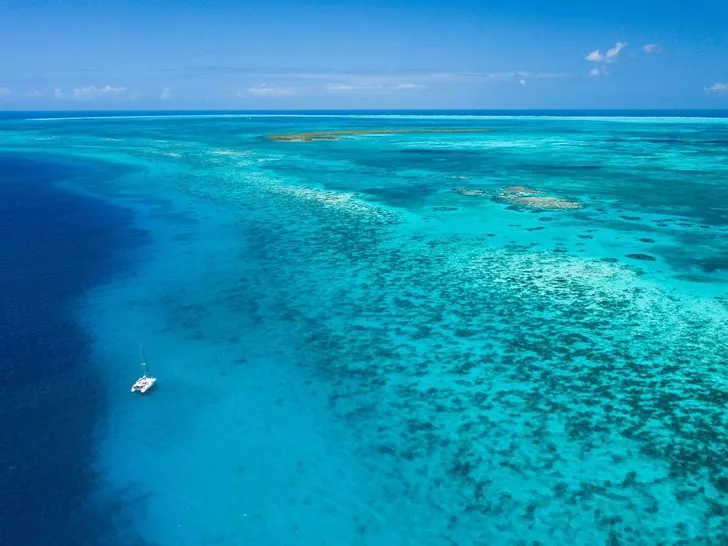 THE BIG LEBOATSKI Fountaine Pajot Aura 51 - aerial shot amidst the blue sea THE BIG LEBOATSKI Fountaine Pajot Aura 51 - aerial shot amidst the blue sea