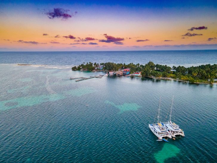 THE BIG LEBOATSKI Fountaine Pajot Aura 51 - anchored under the golden sky near an island THE BIG LEBOATSKI Fountaine Pajot Aura 51 - anchored under the golden sky near an island