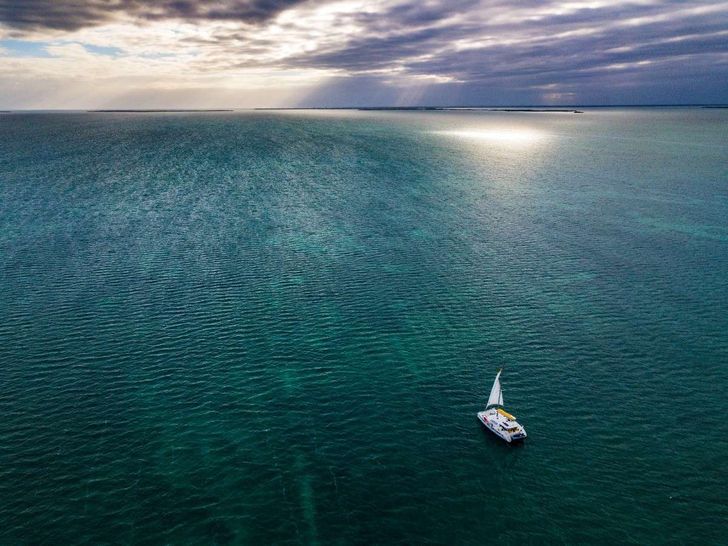 THE BIG LEBOATSKI Fountaine Pajot Aura 51 - drone shot with the catamaran under the sunset THE BIG LEBOATSKI Fountaine Pajot Aura 51 - drone shot with the catamaran under the sunset