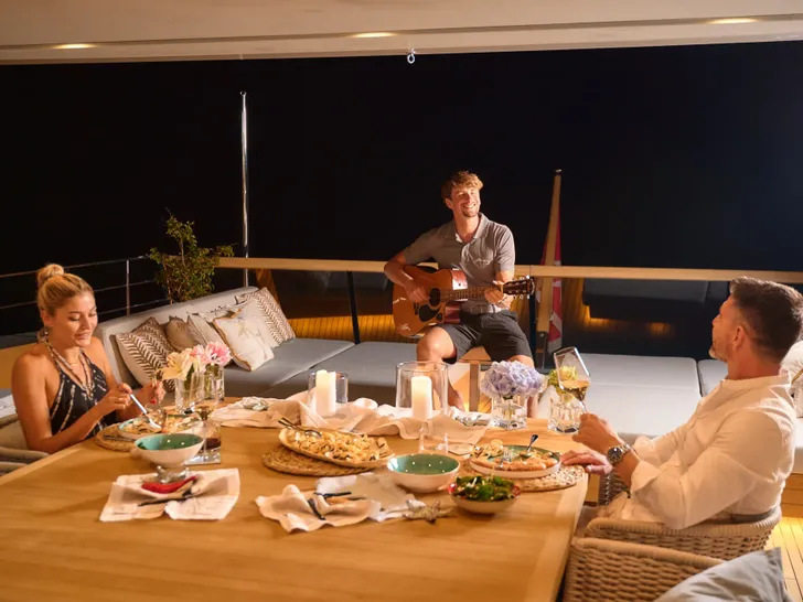 ZULU 3 Sanlorenzo SD112 - guests having a romantic alfresco dinner ZULU 3 Sanlorenzo SD112 - guests having a romantic alfresco dinner