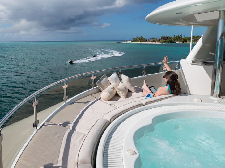 PIPE DREAM - Westport 130,guest relaxing beside the jacuzzi