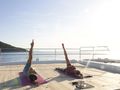 CRAZY HORSE Lagoon 78 - guests having a yoga session onboard CRAZY HORSE Lagoon 78 - guests having a yoga session onboard