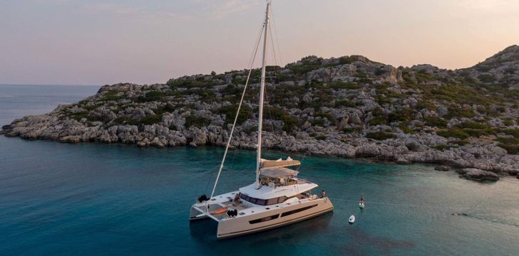 Crewed Catamaran at Anchor at Sunset