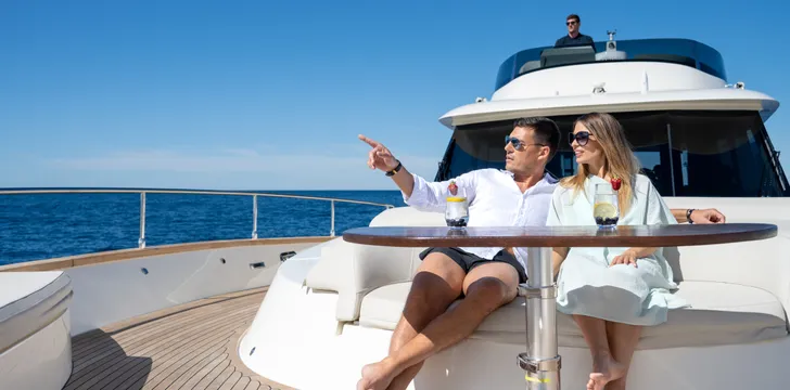 Couple enjoying drinks on a luxury motor yacht