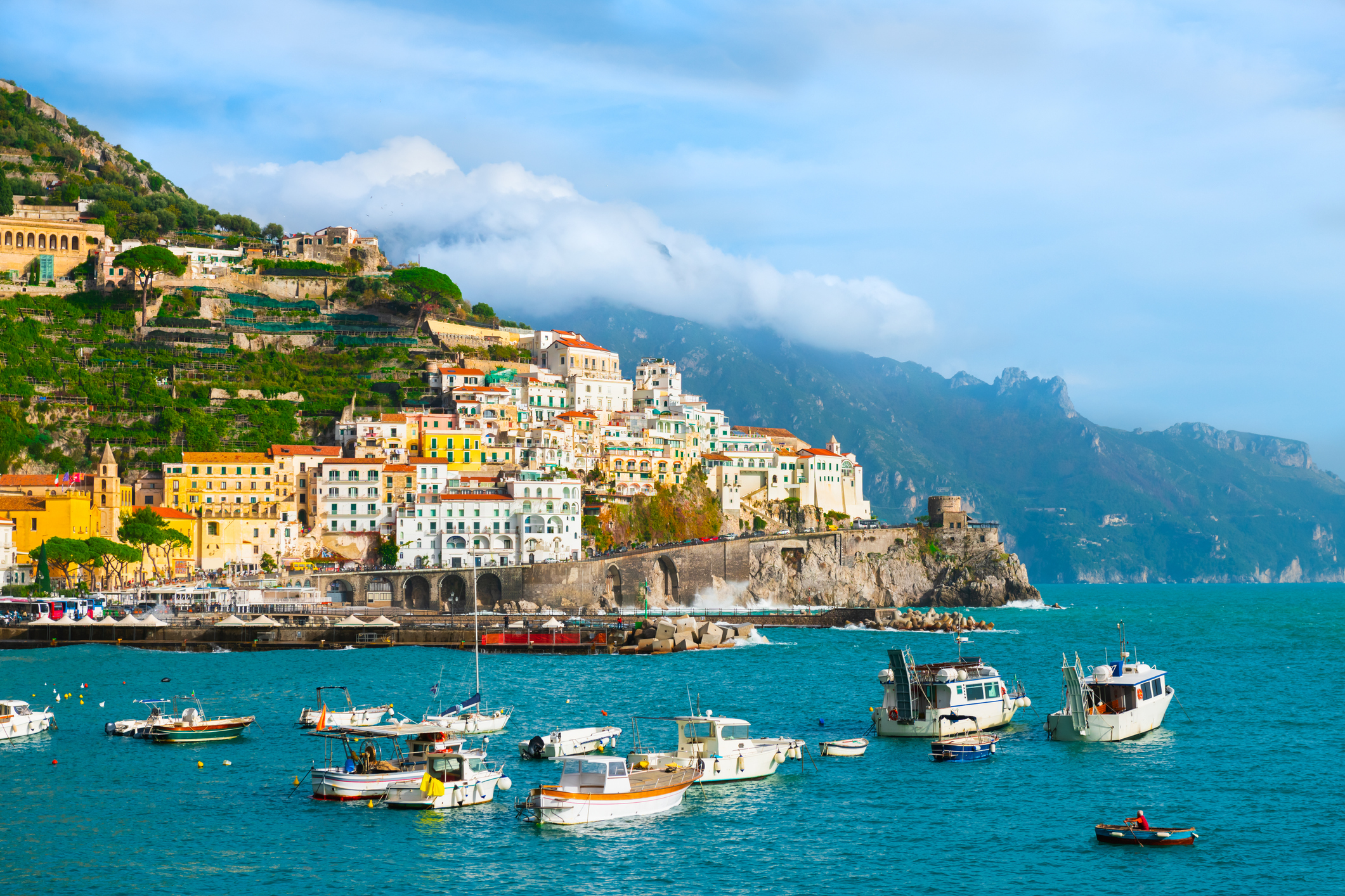 aerial shot of the amalfi town in the amalfi coast with yachts anchored near its port