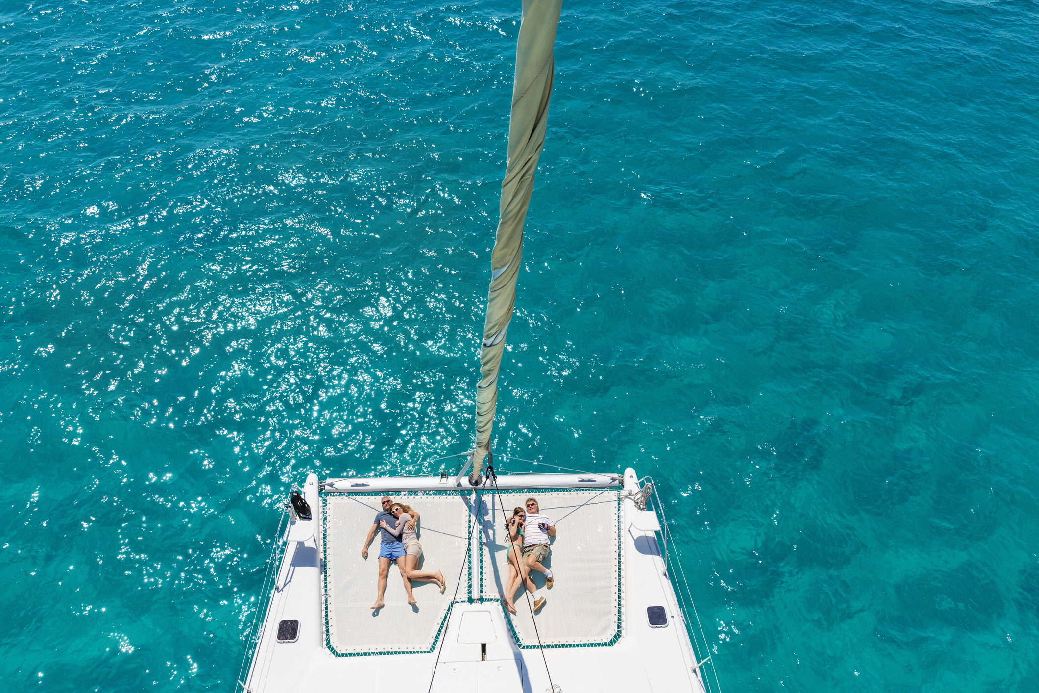 guests enjoying a sunbathing session in their amalfi coast catamaran yacht cruise