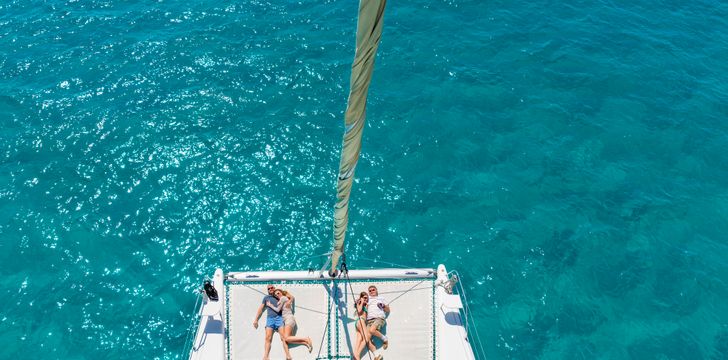 guests enjoying a sunbathing session in their amalfi coast catamaran yacht cruise