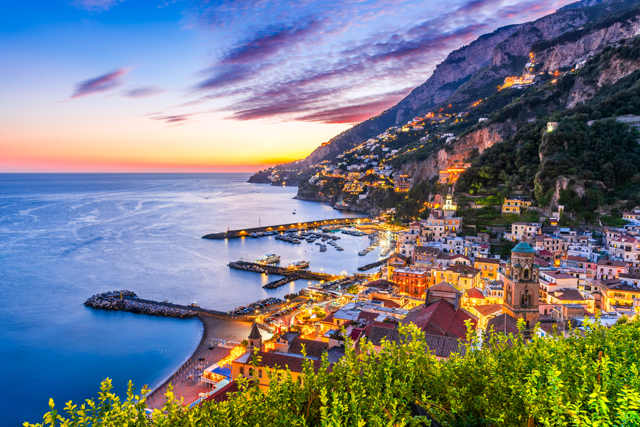 beautiful sunset view of the amalfi coast with yachts lined in its iconic ports