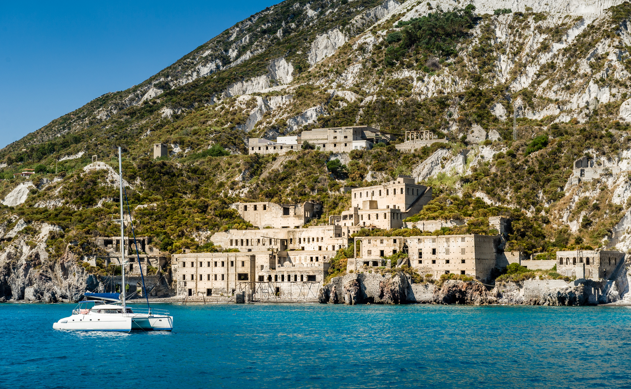 a catamaran anchored off the coast of lipari during a sicily yacht charter